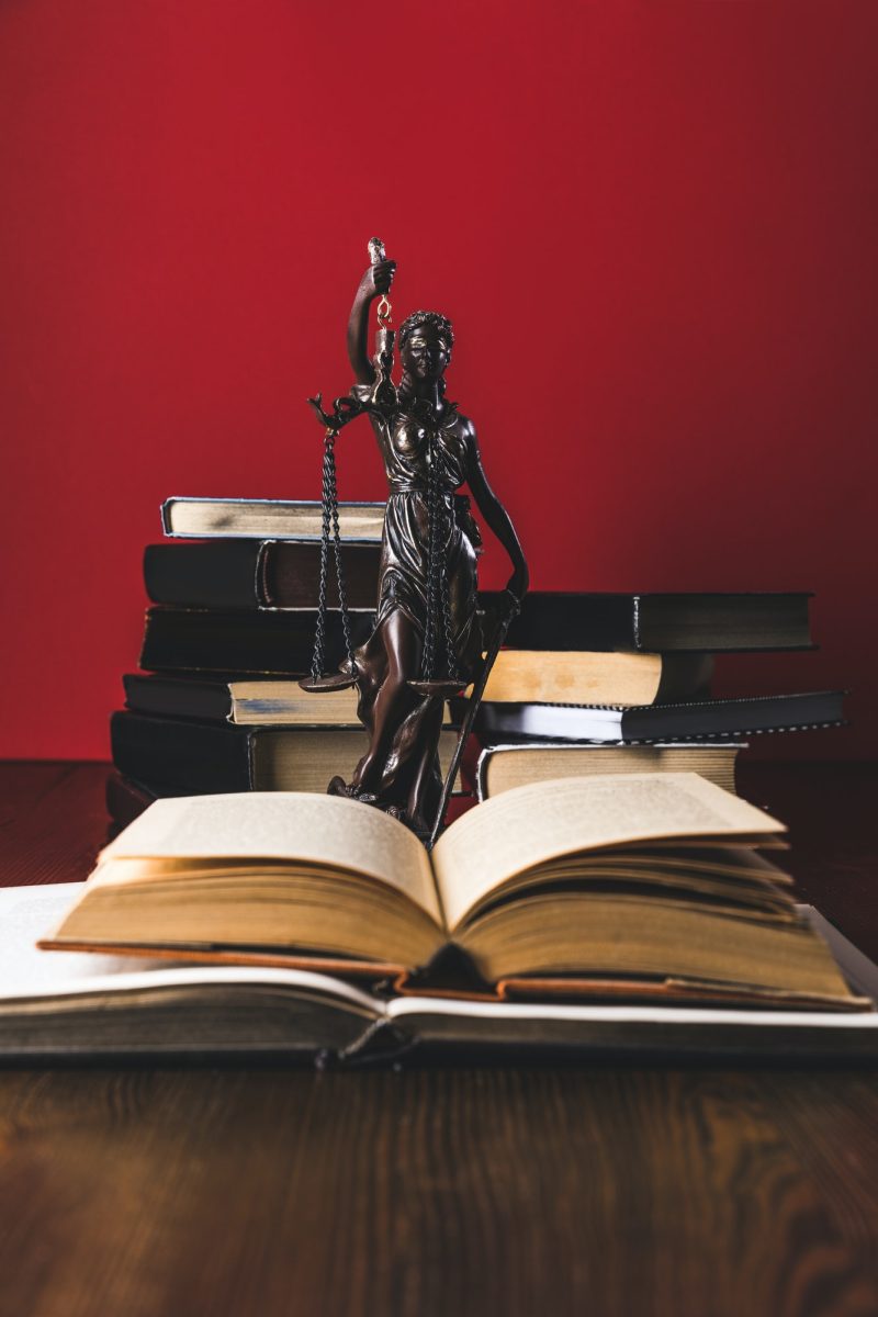 opened-juridical-books-with-lady-justice-statue-on-wooden-table-law-concept-1.jpg